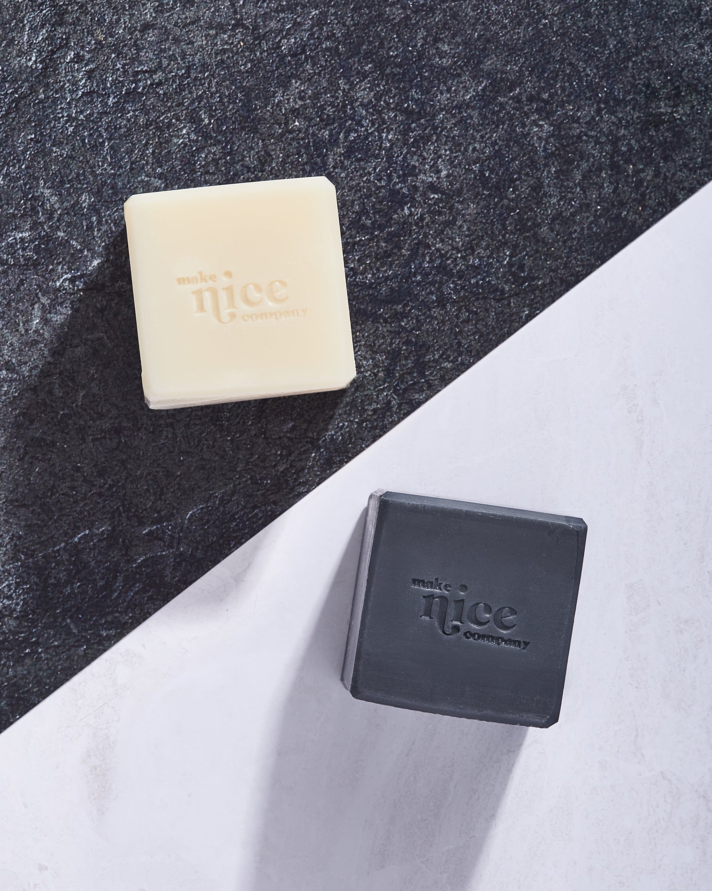 Make Nice Company Unscented Solid Dish Soap block and Charcoal Solid Dish Soap block on black and white background.