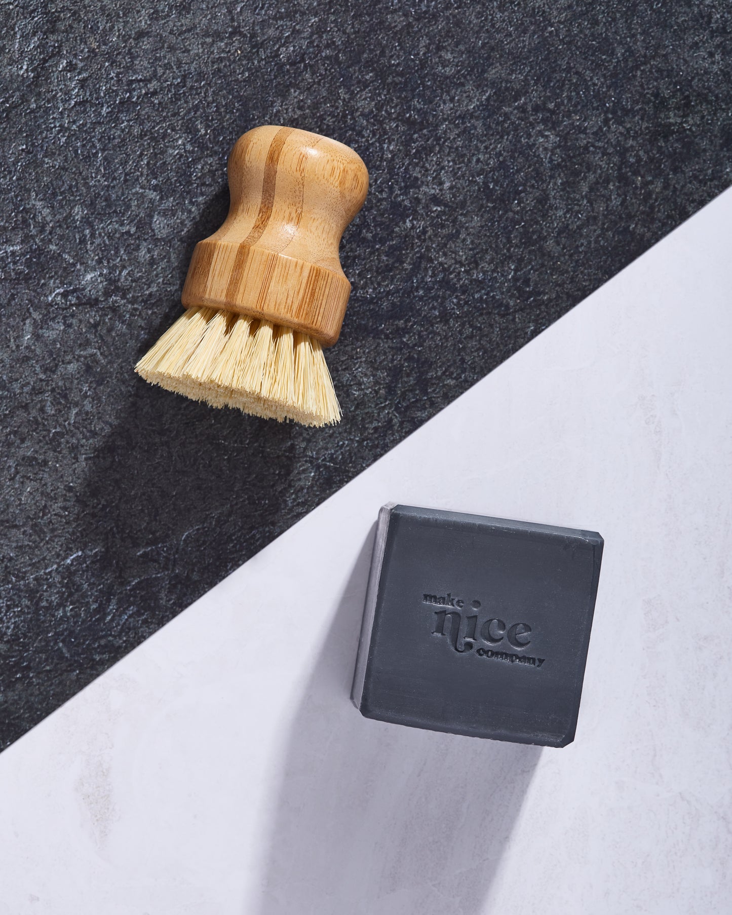 Make Nice Company Charcoal Solid Dish Soap and Scrubber Brush on black and white background.