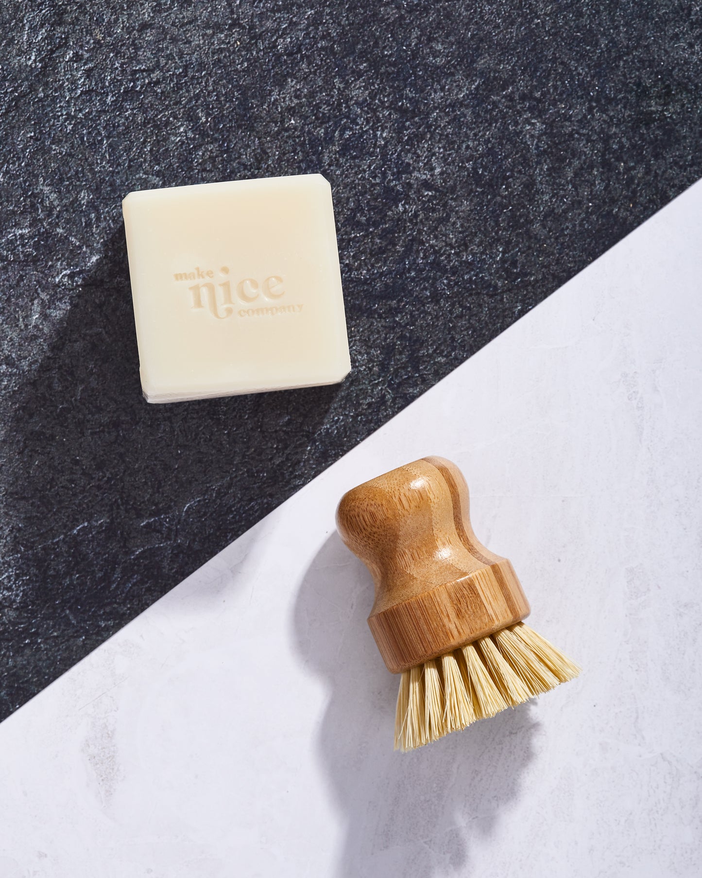 Make Nice Company unscented Solid Dish Soap and Scrubber Brush on black and white background.